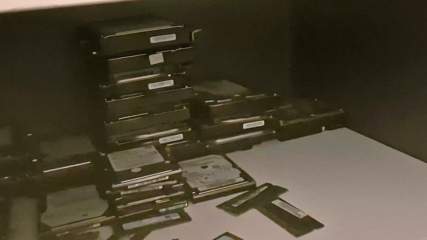 Spare hard drives stacked on a shelf